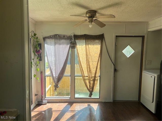 interior space with a textured ceiling, washer / dryer, ceiling fan, and hardwood / wood-style flooring