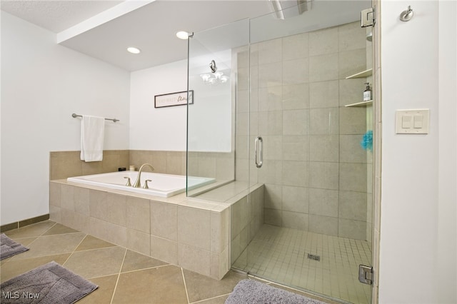 bathroom with independent shower and bath and tile patterned floors