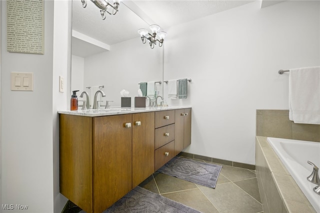 bathroom with tile patterned flooring, a relaxing tiled tub, and vanity