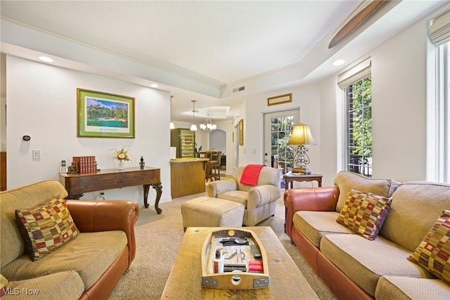 carpeted living room featuring a tray ceiling