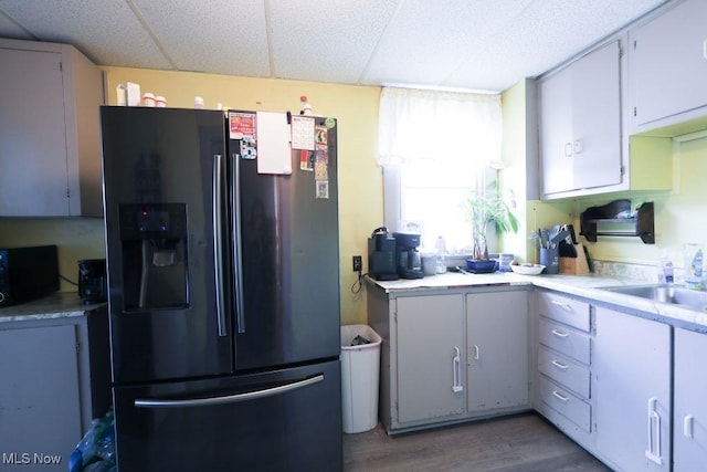 1631 Globe St, East Liverpool, OH 43920 - kitchen with black appliances, a sink, wood finished floors, a paneled ceiling, and light countertops