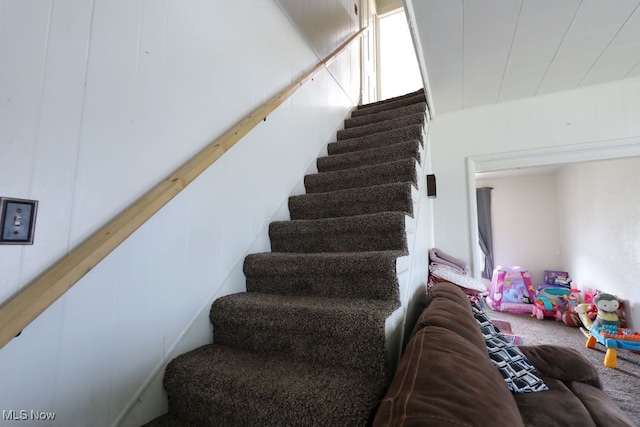 staircase featuring carpet flooring