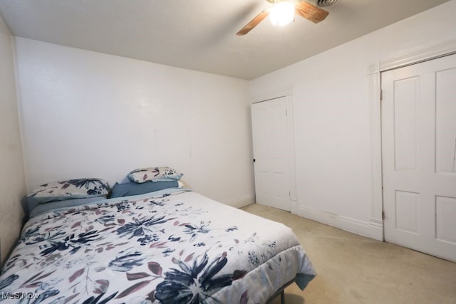 bedroom with light carpet and ceiling fan