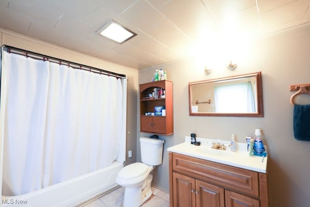 full bathroom featuring vanity, shower / bath combo with shower curtain, toilet, and tile patterned flooring