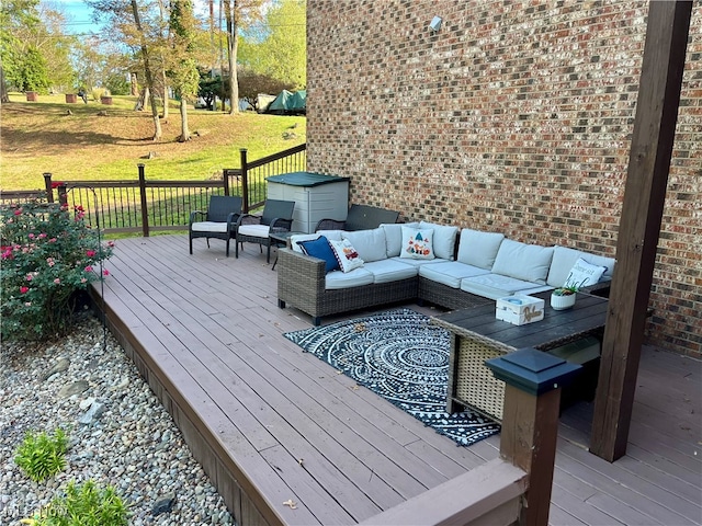 wooden deck featuring an outdoor hangout area and a lawn