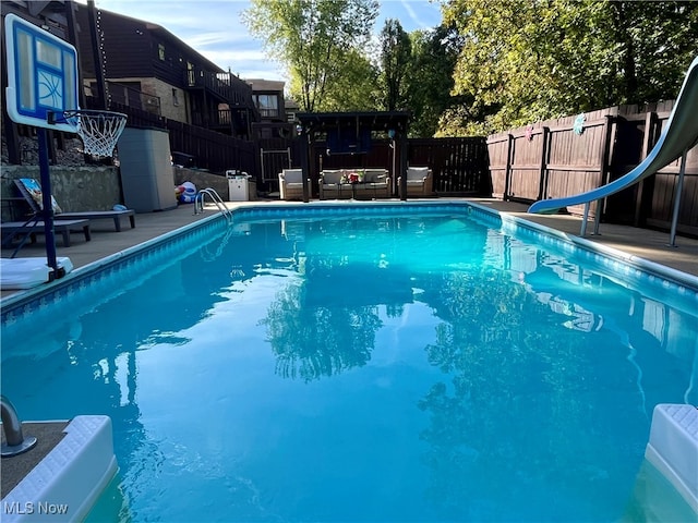 view of pool featuring a water slide