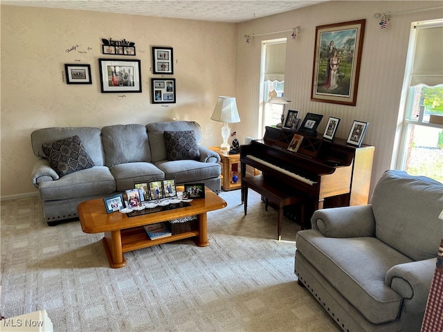 living room featuring a textured ceiling and light colored carpet