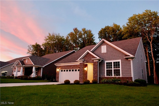 view of front of home featuring a lawn and a garage