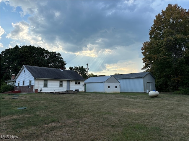 exterior space with a front lawn and an outbuilding