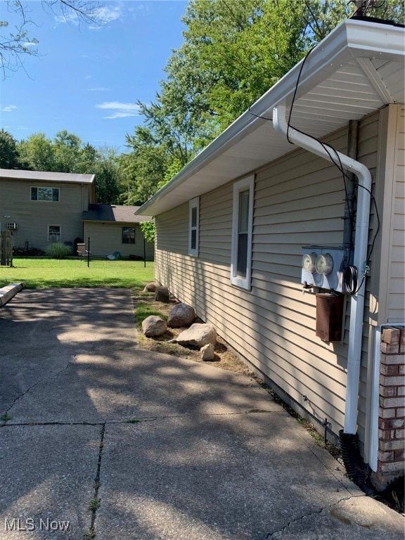 view of side of property with a lawn