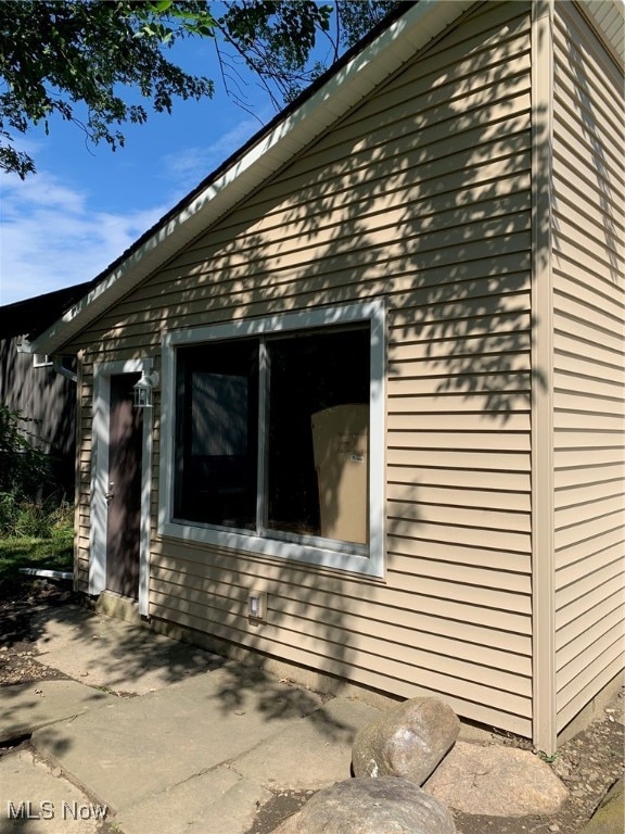 view of side of property featuring a patio area