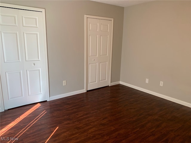 unfurnished bedroom featuring dark hardwood / wood-style floors