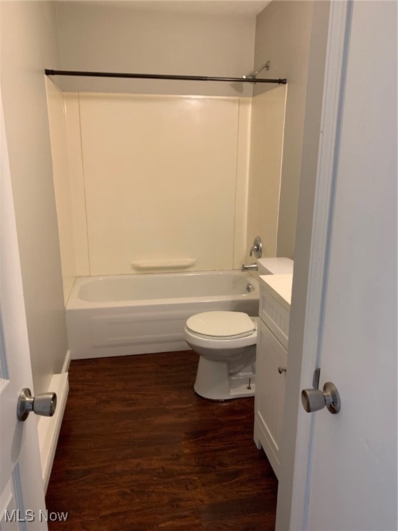 full bathroom with toilet, hardwood / wood-style flooring, bathing tub / shower combination, and vanity