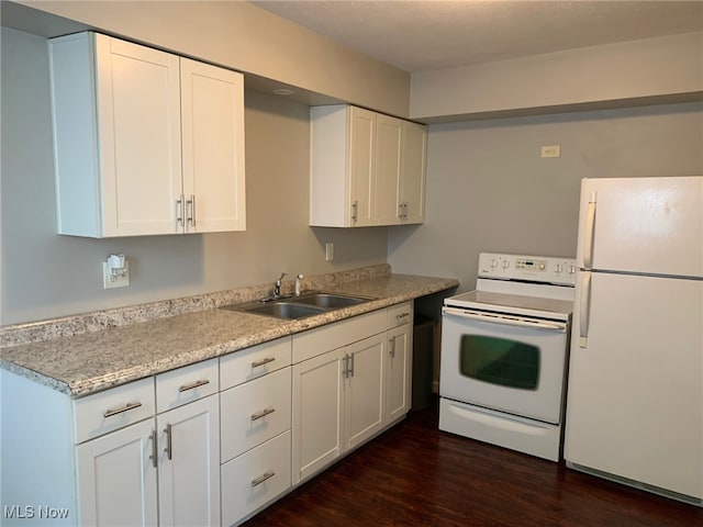 kitchen featuring white cabinets, white appliances, dark hardwood / wood-style flooring, and sink