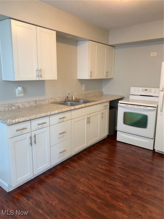 kitchen featuring dark wood-type flooring, white cabinets, white appliances, and sink