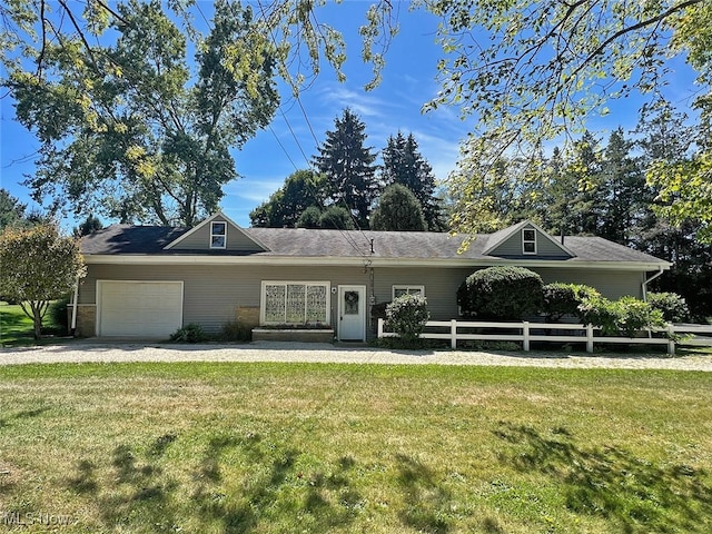 ranch-style house featuring a front lawn and a garage