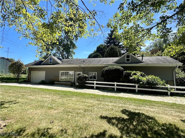 view of home's community with a lawn and a garage