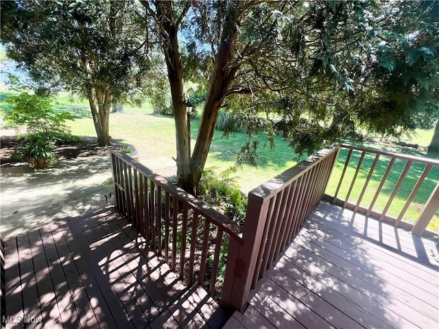 wooden deck featuring a yard