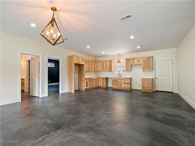 kitchen with light brown cabinets, sink, hanging light fixtures, and an inviting chandelier