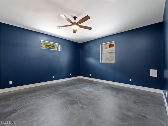 empty room with ceiling fan and a healthy amount of sunlight