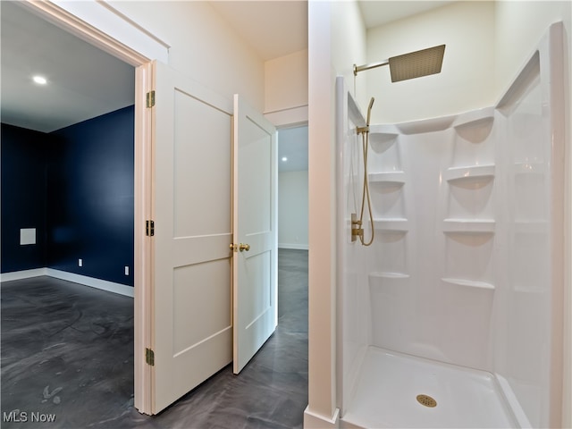 bathroom with concrete flooring and walk in shower