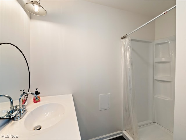 bathroom with curtained shower and sink