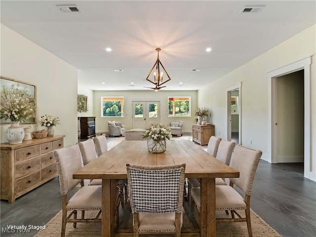 dining space featuring a chandelier and french doors