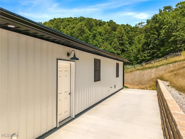 view of property exterior with a patio area