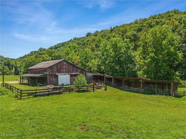 view of yard with a rural view and an outdoor structure