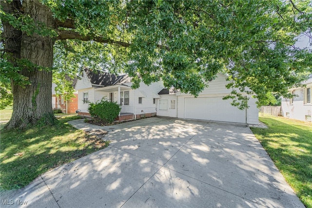 view of front of house with a garage and a front lawn