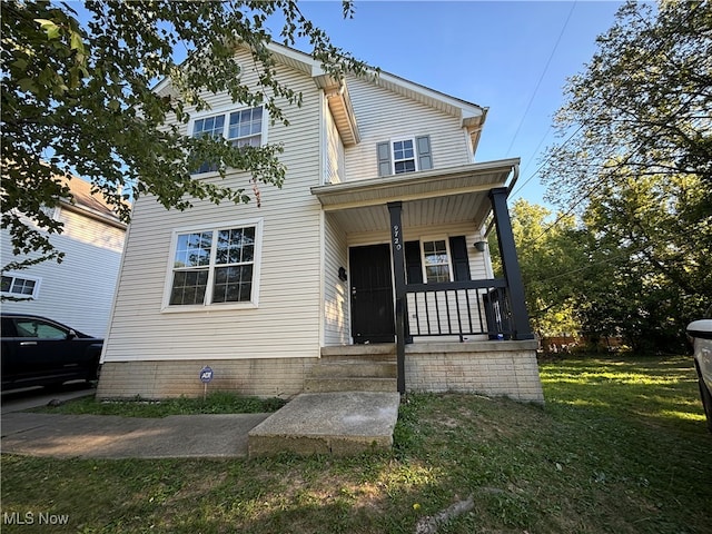 view of front of house featuring a front yard and covered porch