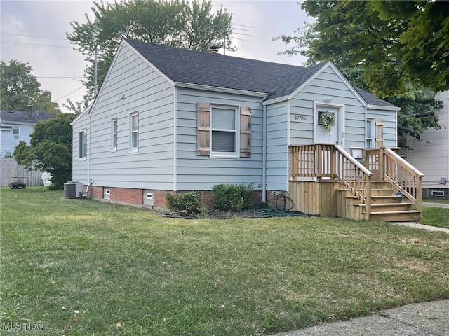 view of front of property featuring cooling unit and a front lawn