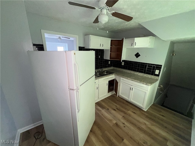 kitchen featuring white cabinetry, dark hardwood / wood-style flooring, sink, ceiling fan, and white refrigerator