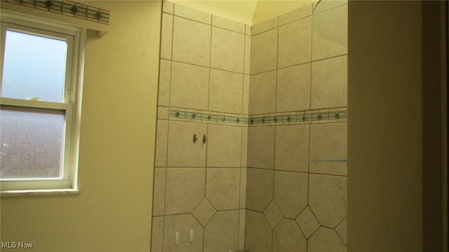 bathroom with tiled shower