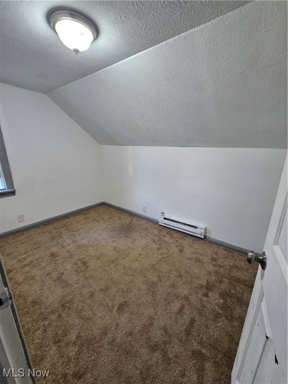 bonus room featuring a textured ceiling, lofted ceiling, a baseboard heating unit, carpet floors, and baseboards