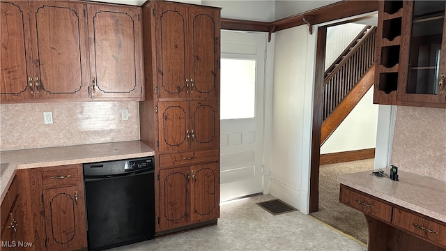 kitchen featuring black dishwasher and tasteful backsplash