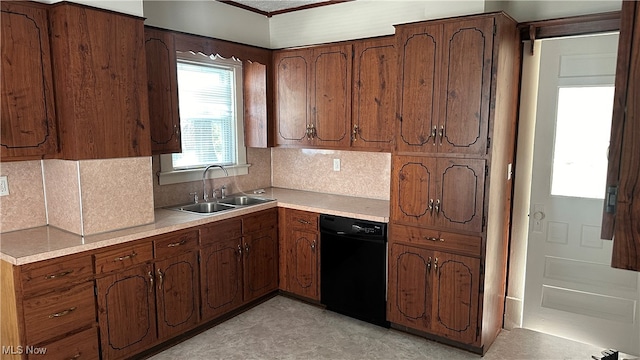 kitchen with black dishwasher, backsplash, and sink