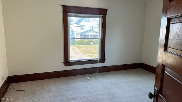 carpeted spare room featuring a healthy amount of sunlight