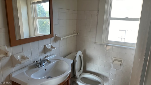 bathroom with tile walls, toilet, decorative backsplash, and vanity