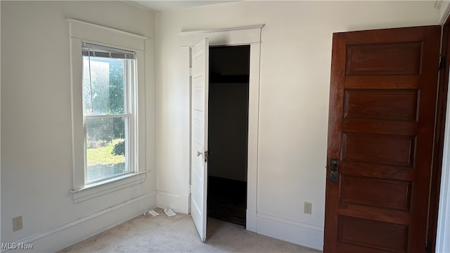 unfurnished bedroom featuring light colored carpet