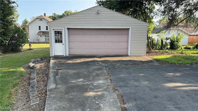 garage featuring a lawn