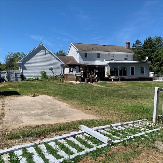 rear view of property with a lawn