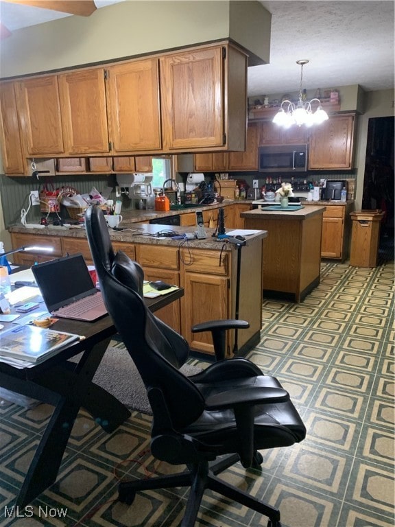 kitchen with a notable chandelier, a center island, and pendant lighting