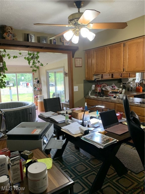 kitchen featuring a textured ceiling and ceiling fan