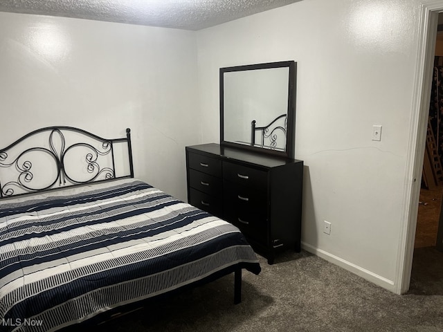 carpeted bedroom featuring a textured ceiling