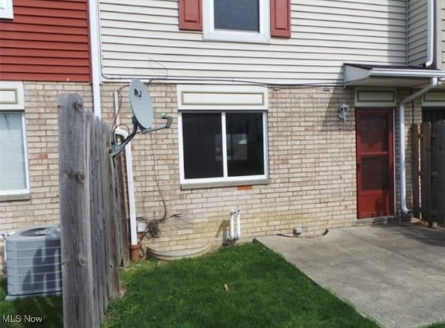 view of home's exterior with a patio area and central air condition unit