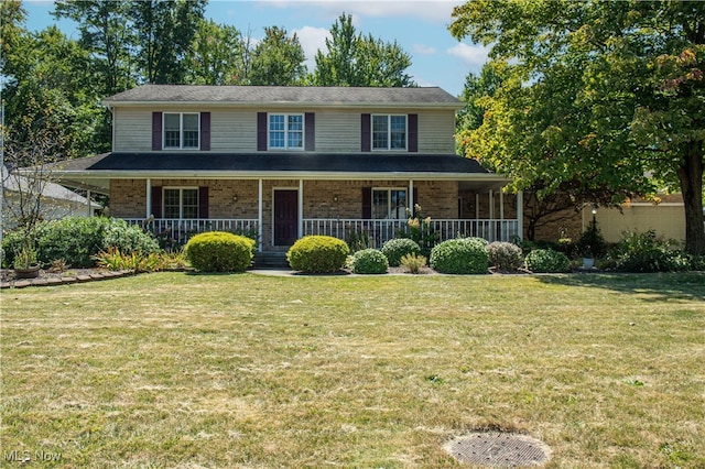 view of front of house with covered porch and a front lawn