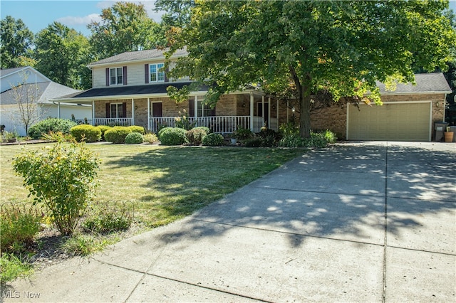 view of front of house with a front lawn, a porch, and a garage