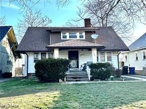 bungalow-style home featuring a front yard