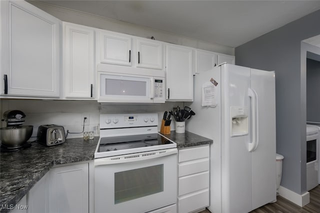 kitchen featuring dark stone counters, white cabinetry, dark hardwood / wood-style floors, and white appliances